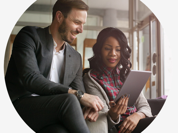 Two team members looking at a tablet 